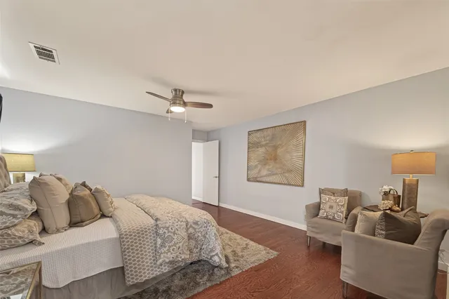 a spacious bedroom with a bed and couch