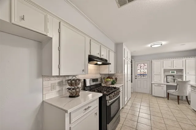 a kitchen with a sink and a stove top oven
