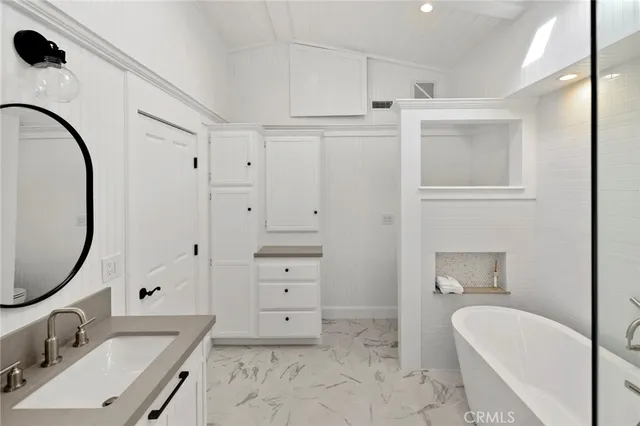a spacious bathroom with a sink double vanity and a mirror