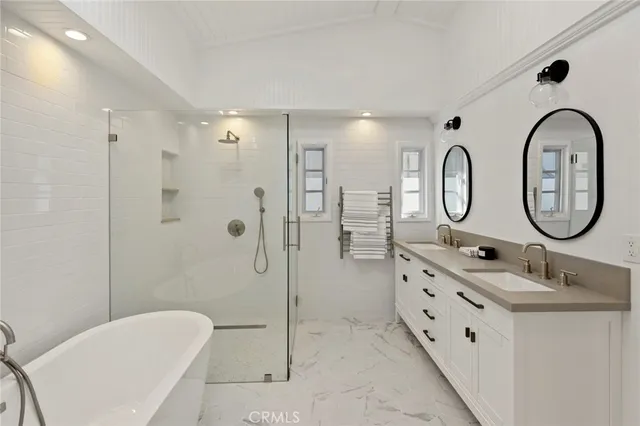 a bathroom with a double vanity sink mirror and toilet