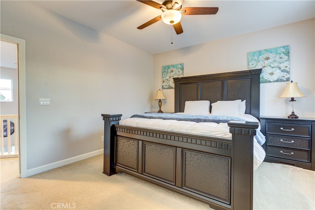 1941 Devaul Ranch Drive San Luis Obispo, CA 93405 - Photo 15 of 58 a bedroom with a bed and a chandelier