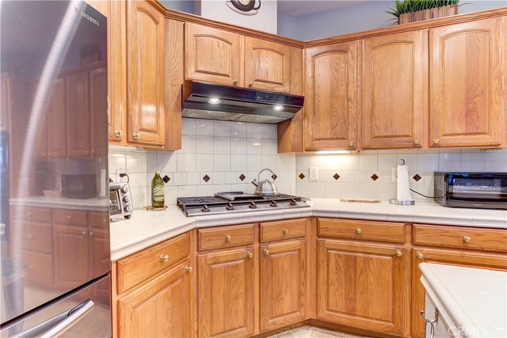 1941 Devaul Ranch Drive San Luis Obispo, CA 93405 - Photo 27 of 58 a kitchen with stainless steel appliances granite countertop a sink a stove and cabinets