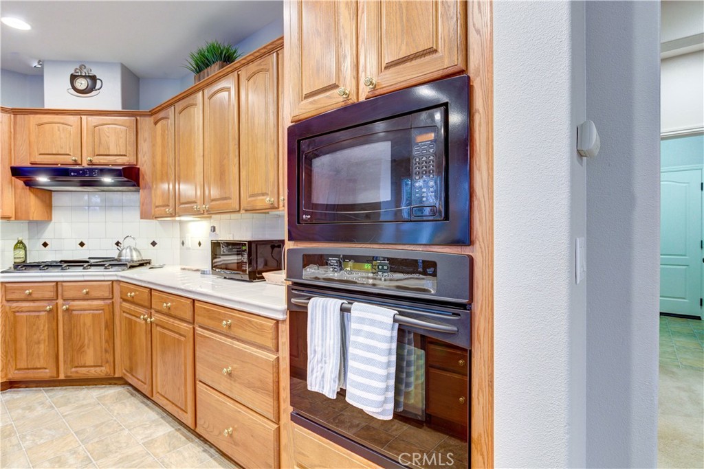 1941 Devaul Ranch Drive San Luis Obispo, CA 93405 - Photo 29 of 58 a kitchen with stainless steel appliances granite countertop a stove and cabinets