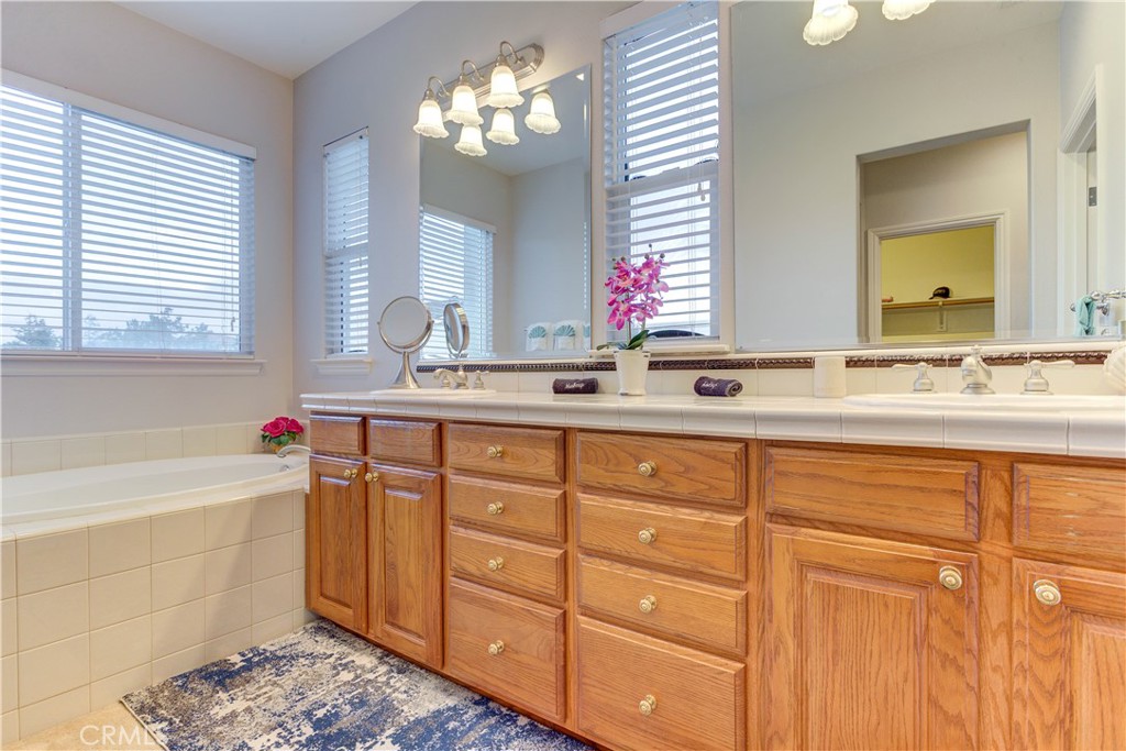 1941 Devaul Ranch Drive San Luis Obispo, CA 93405 - Photo 31 of 58 a bathroom with a sink and a mirror