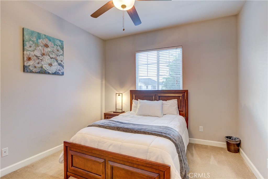1941 Devaul Ranch Drive San Luis Obispo, CA 93405 - Photo 38 of 58 a bedroom with a large bed and a chandelier