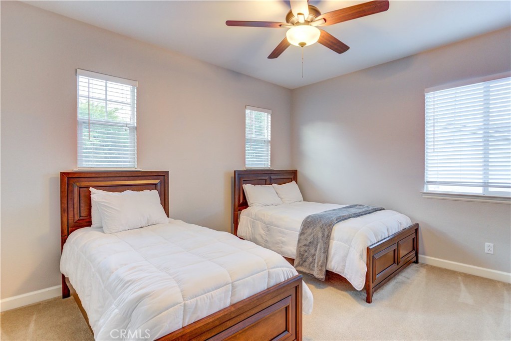1941 Devaul Ranch Drive San Luis Obispo, CA 93405 - Photo 41 of 58 a bedroom with two beds and a chandelier