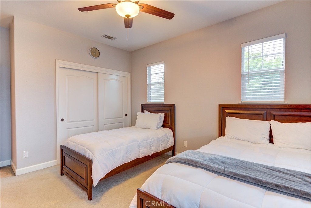 1941 Devaul Ranch Drive San Luis Obispo, CA 93405 - Photo 42 of 58 a bedroom with two beds and a chandelier