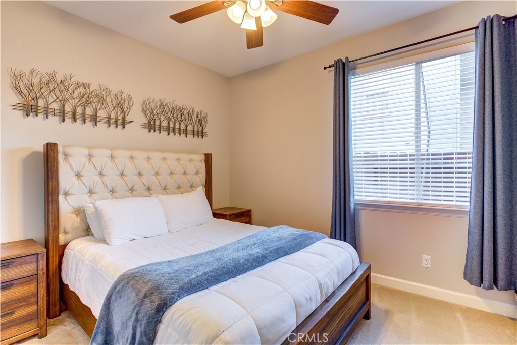 1941 Devaul Ranch Drive San Luis Obispo, CA 93405 - Photo 52 of 58 a bedroom with a large bed and a chandelier