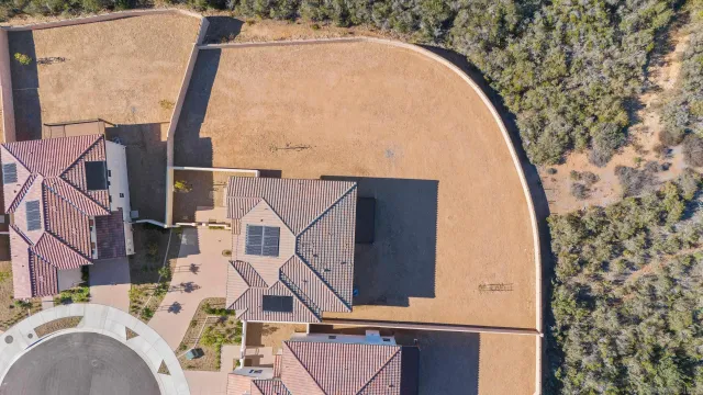 an aerial view of a house with swimming pool