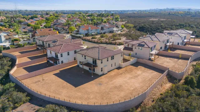 an aerial view of a house with a swimming pool lake view and mountain view