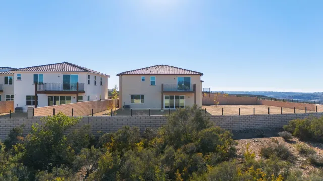 a front view of a house with a yard and balcony