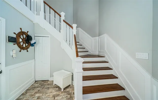 a living room with furniture flat screen tv and a large window