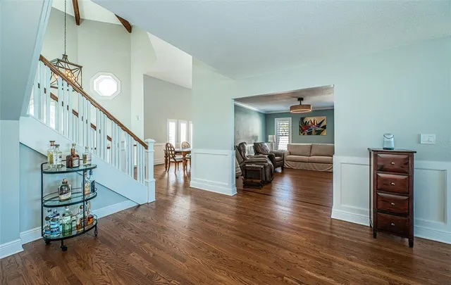 a kitchen with stainless steel appliances granite countertop a stove a sink and a white wooden cabinets