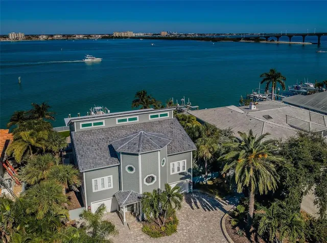 an aerial view of a house with outdoor space and lake view