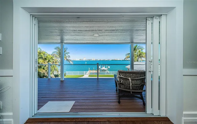 a bedroom with a bed chandelier and a window