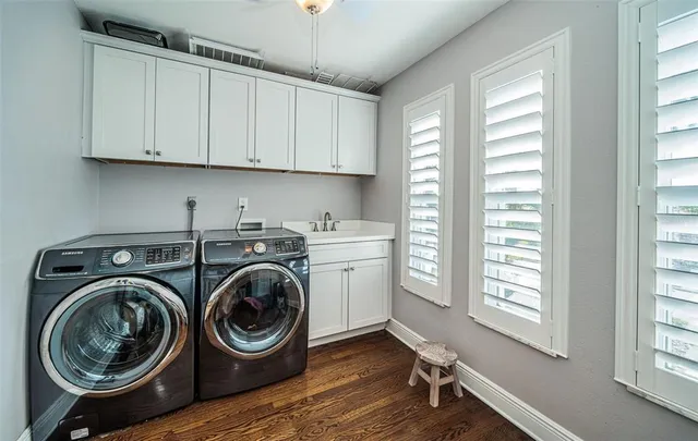an aerial view of residential houses with outdoor space and lake view