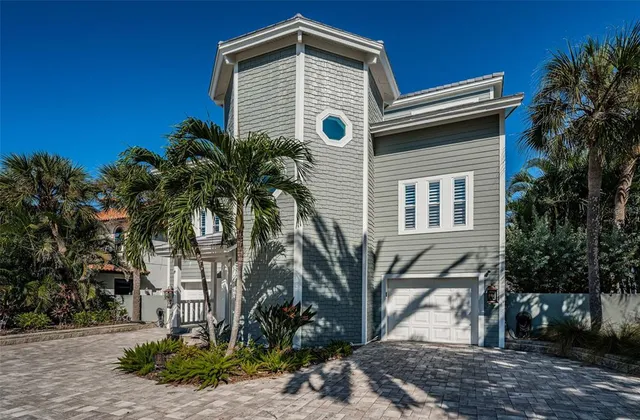 a front view of a house with a yard table and chairs