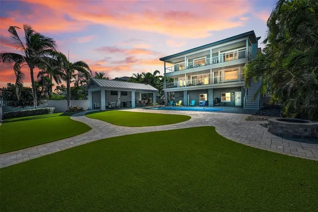 a view of entryway and kitchen with wooden floor