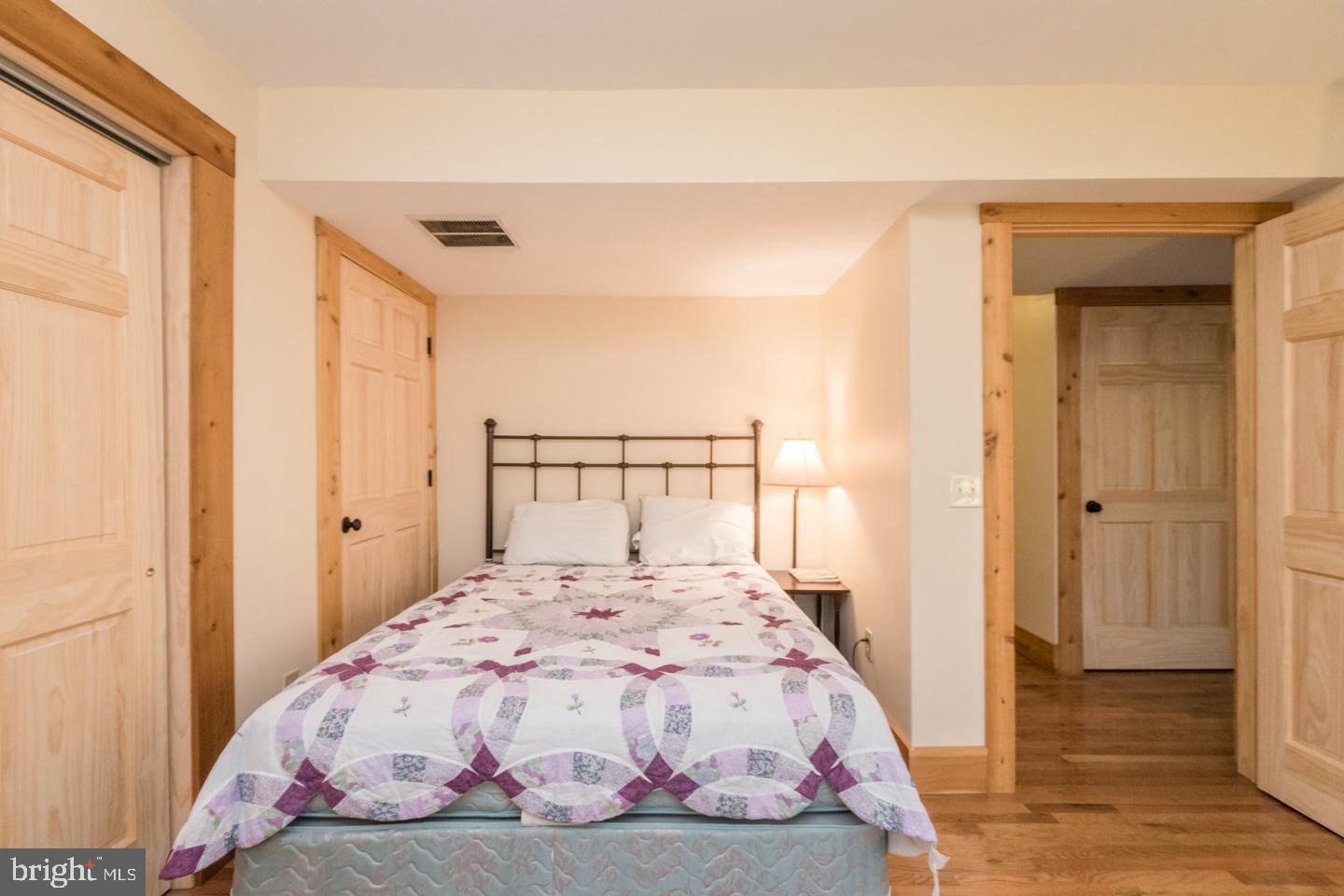 460 Susan Road Basye, VA 22842 - Photo 54 of 88 a bedroom with a bed and wooden floor