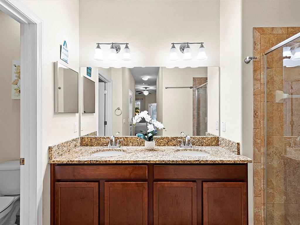 1716 Hadden Hall Place Trinity, FL 34655 - Photo 22 of 75 a bathroom with a granite countertop sink and a mirror