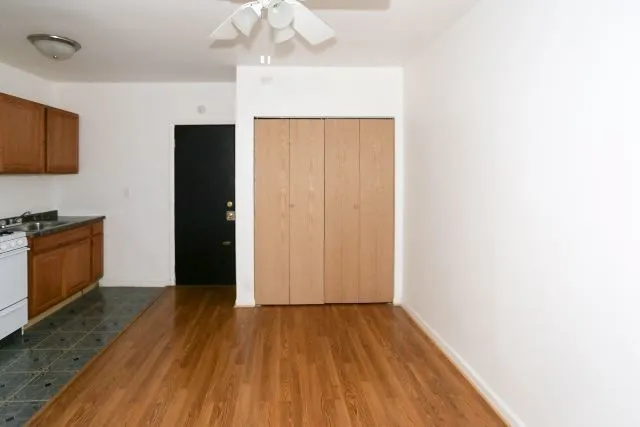 a view of an empty room with wooden floor