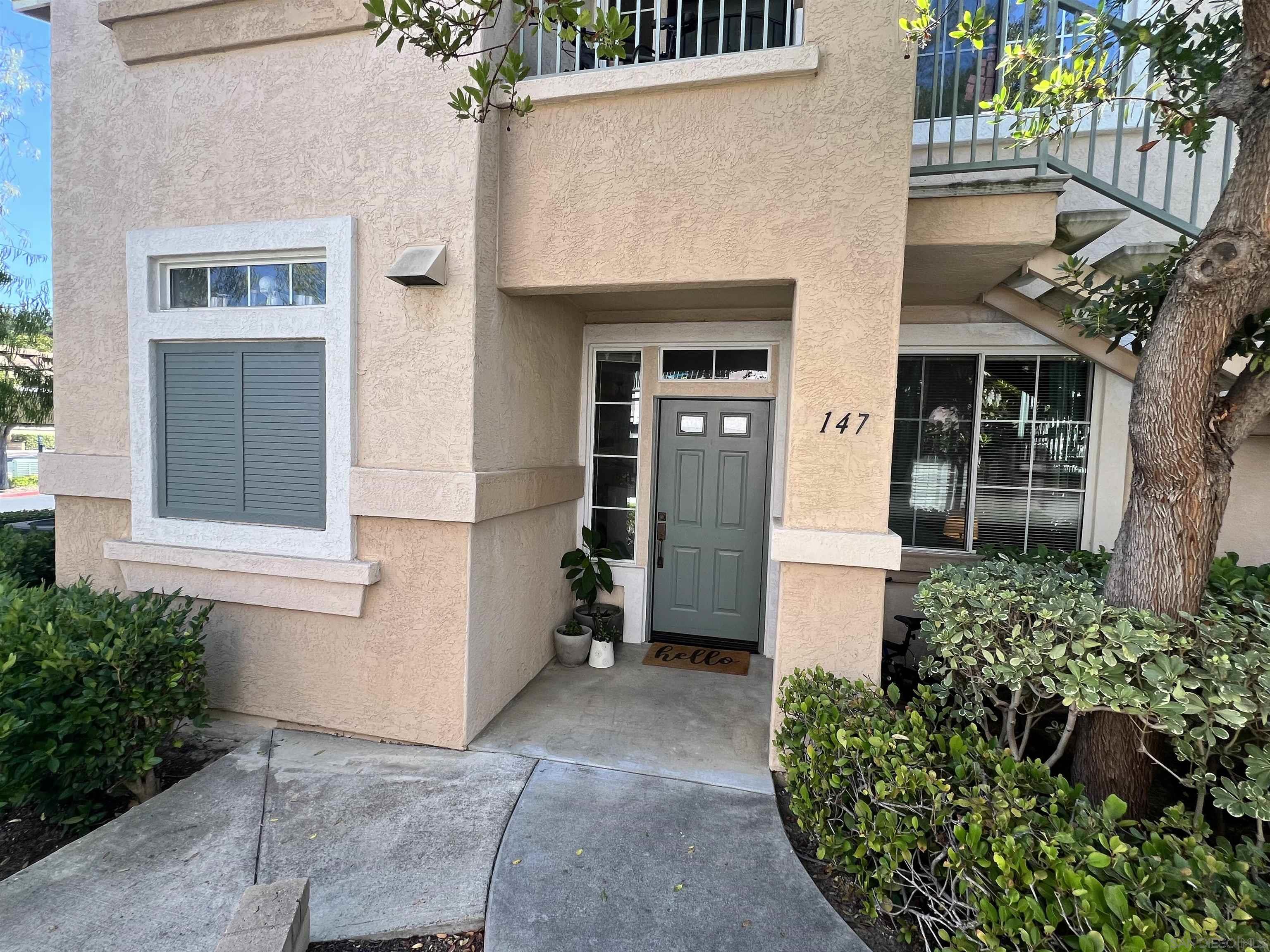 10750 Sabre Hill Drive, Unit 147 San Diego, CA 92128 - Photo 1 of 33 front view of a house with a small yard