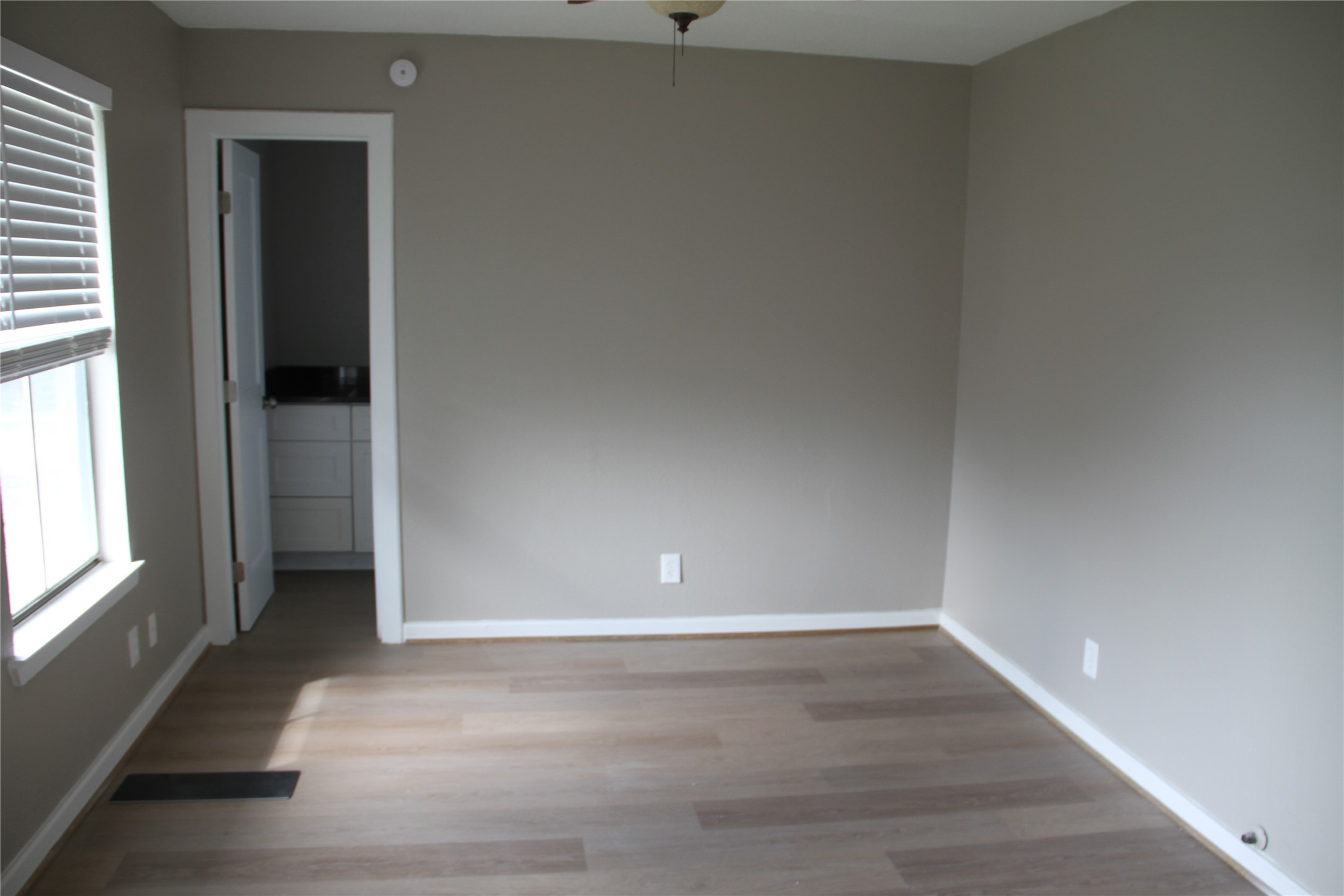 5400 Sheldon Street, Unit B Houston, TX 77008 - Photo 16 of 20 an empty room with wooden floor and windows