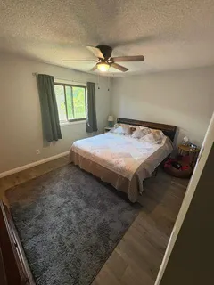a bed sitting in a bedroom next to a window