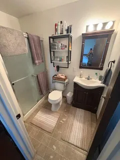 a bathroom with a sink mirror vanity and toilet