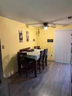 a view of a dining room with furniture and wooden floor