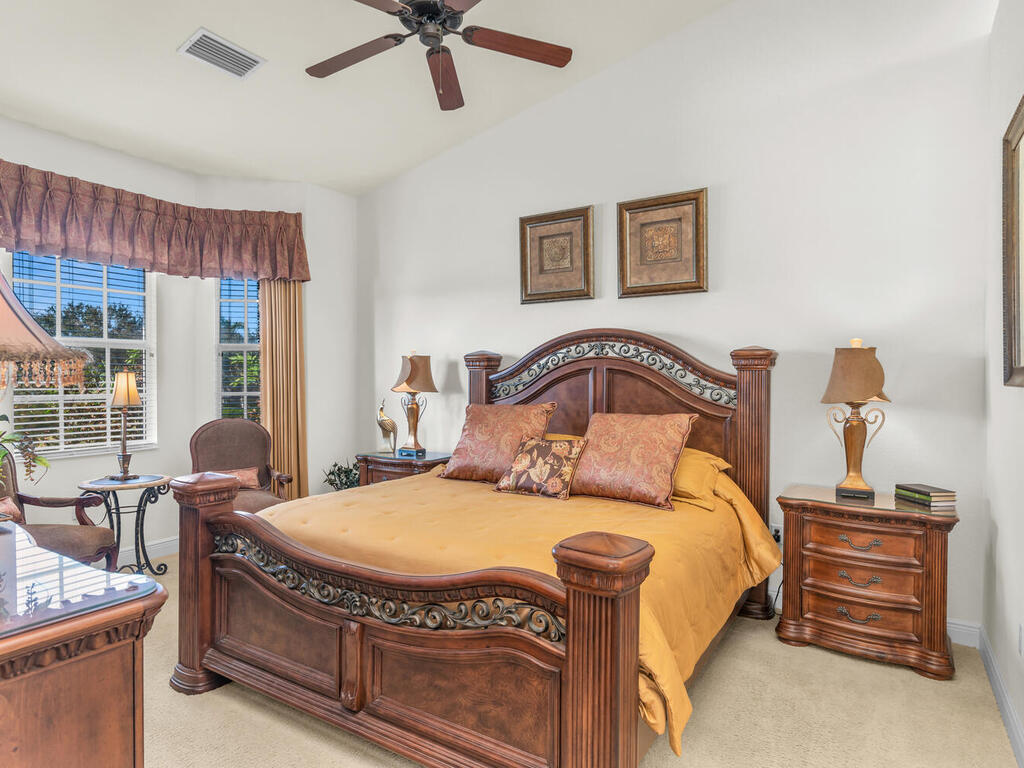 7869 Hawthorne, Unit 303 Naples, FL 34113 - Photo 23 of 52 a bedroom with a bed and wooden floor