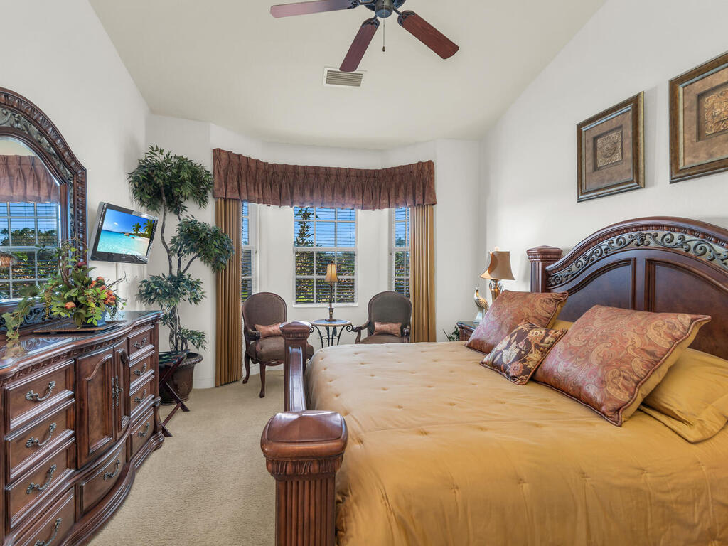 7869 Hawthorne, Unit 303 Naples, FL 34113 - Photo 24 of 52 a bedroom with a bed and wooden floor