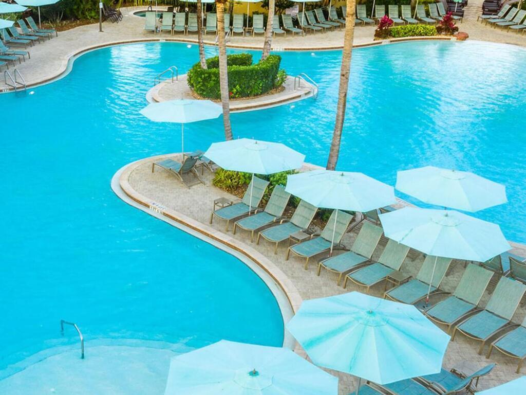 7869 Hawthorne, Unit 303 Naples, FL 34113 - Photo 51 of 52 a view of a swimming pool with chairs