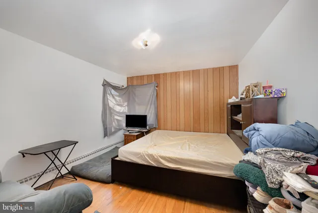 a bedroom with a bed and a chair