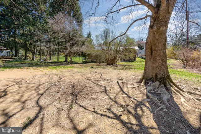 a view of a backyard with chair and table in the patio