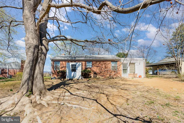 a view of a house with a yard covered in snow
