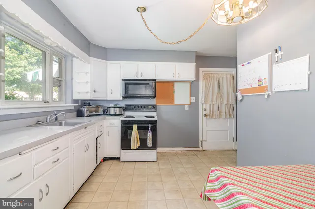 a kitchen with a sink stove and microwave