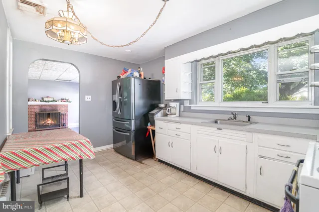 a kitchen with a sink stainless steel appliances and cabinets