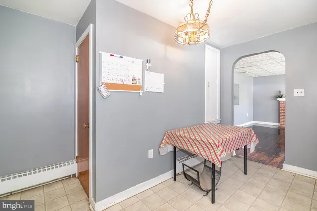 a room with a bed and chandelier