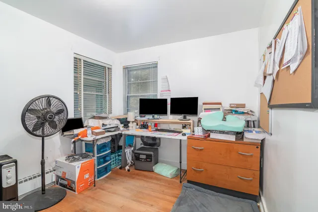 a view of a workspace with furniture and a window
