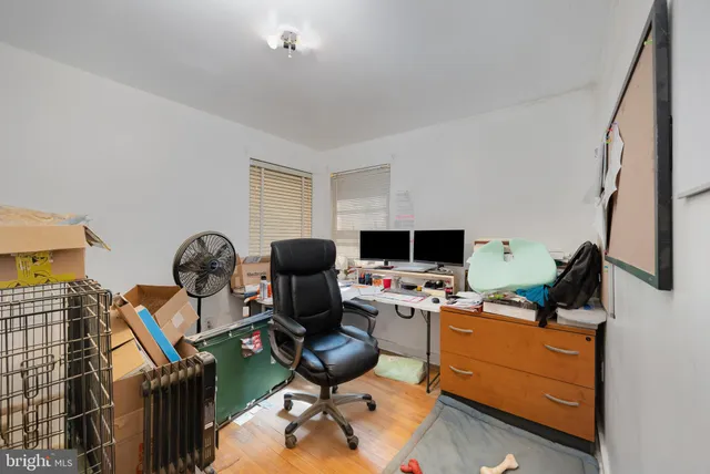 a view of a workspace with furniture and a window