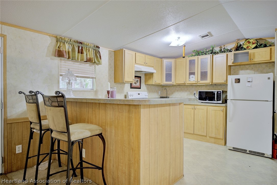 2500 Arbuckle Shrs Road Frostproof, FL 33843 - Photo 13 of 18 a kitchen with a refrigerator and cabinets