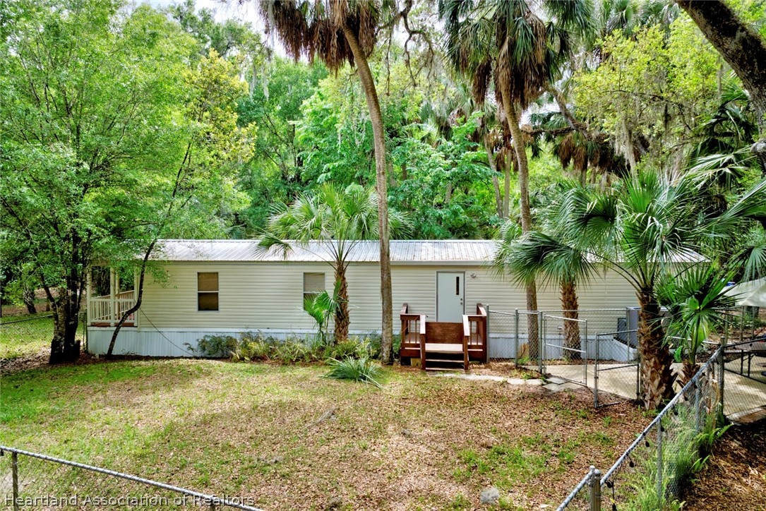 2500 Arbuckle Shrs Road Frostproof, FL 33843 - Photo 2 of 18 a view of backyard of house with outdoor seating and green space