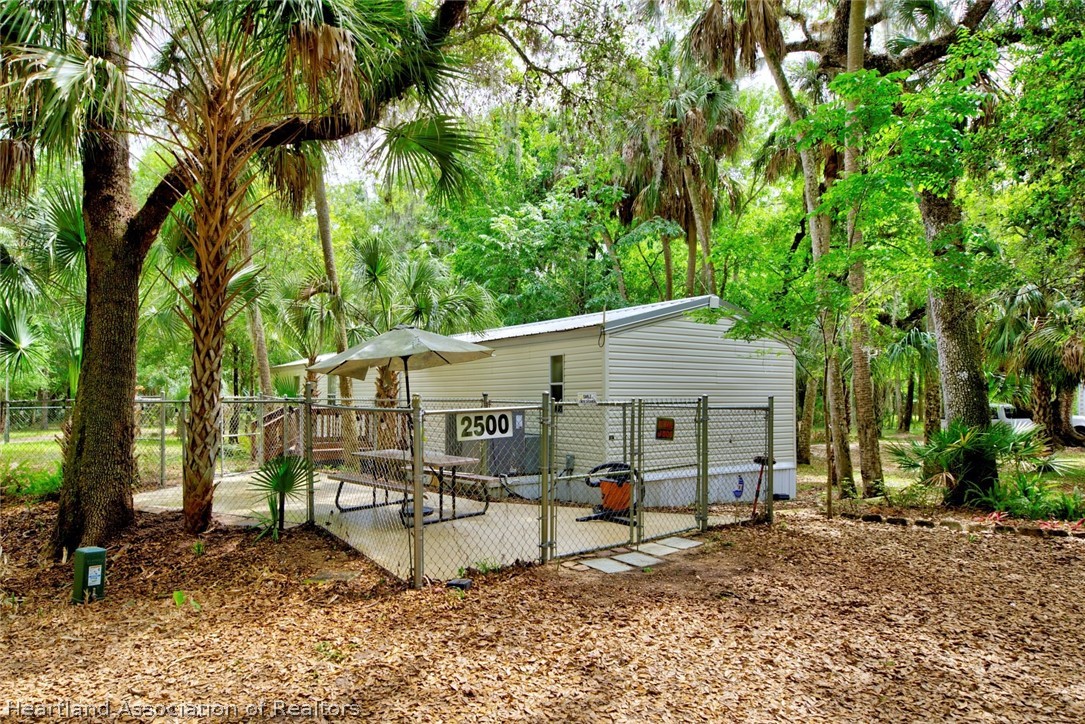 2500 Arbuckle Shrs Road Frostproof, FL 33843 - Photo 3 of 18 a view of a house with backyard and a tree