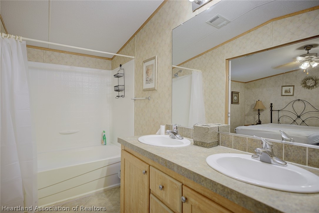 2500 Arbuckle Shrs Road Frostproof, FL 33843 - Photo 7 of 18 a bathroom with a granite countertop bathtub shower sink vanity and mirror