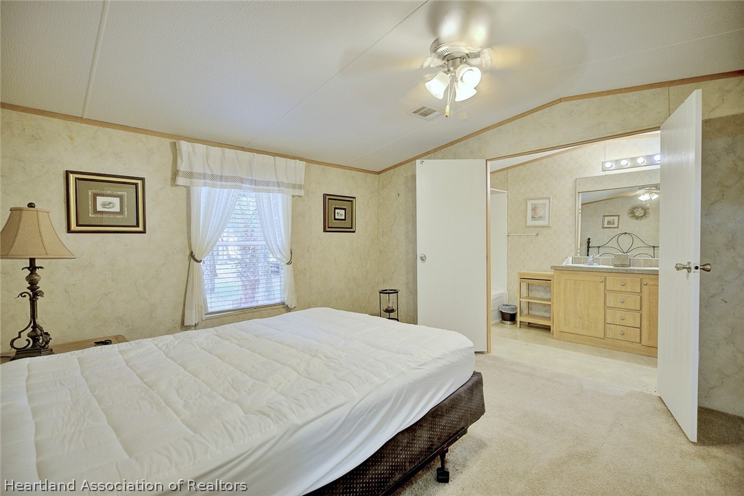 2500 Arbuckle Shrs Road Frostproof, FL 33843 - Photo 8 of 18 a bedroom with a bed and a chandelier
