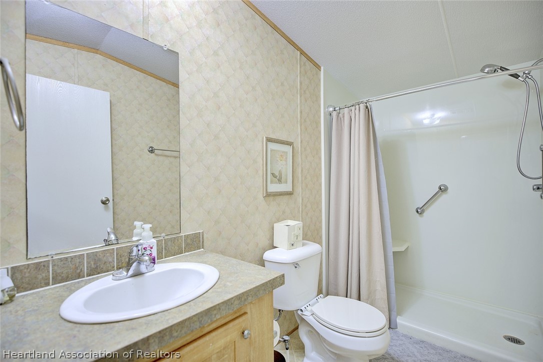 2500 Arbuckle Shrs Road Frostproof, FL 33843 - Photo 9 of 18 a bathroom with a sink a toilet a mirror and shower