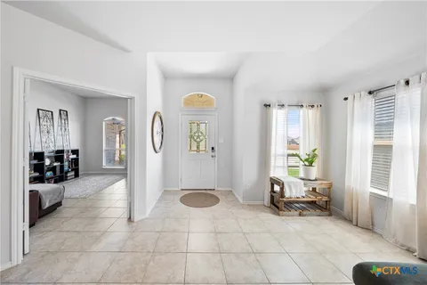 a spacious bathroom with a glass door shower and a sink