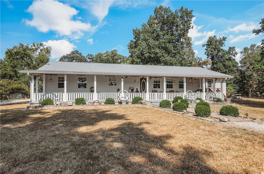 21587 West Hickory Flat Road Springdale, AR 72764 - Photo 7 of 45 Welcoming 3-bedroom country home with a metal roof and an expansive covered front porch, situated on 49.582± acres.