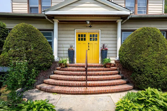 a front view of a house with a garden